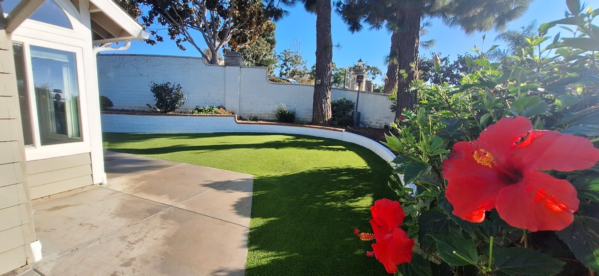 Backyard turf installation with landscaping in Vista, CA